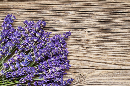 Lavender flowers bouquet on old wooden background. Copy space  top view. Summer background