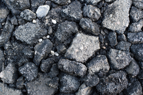 Pieces of asphalt pavement in the hole in the road