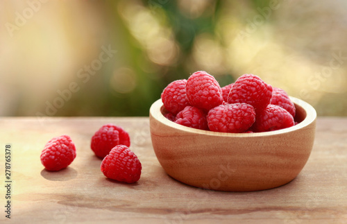 Wooden bowl of raspberry for healthy eating 