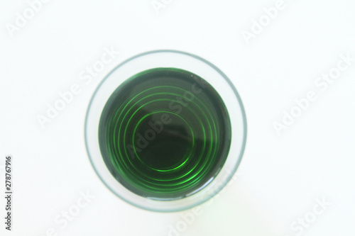 Glass of green liquid on white background, São Paulo, Brazil photo