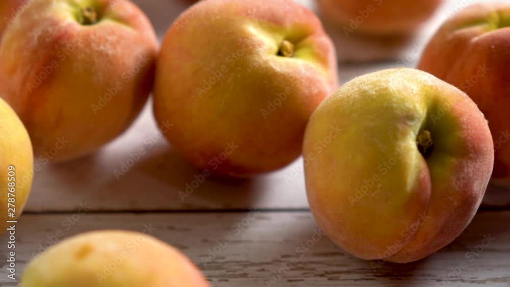 Extreme closeup with slider to the right of ripe peaches on a rustic painted wood background with shallow depth of field. Extreme closeup with slider to the right of ripe peaches on a rustic painted wood background with shallow depth of field.
