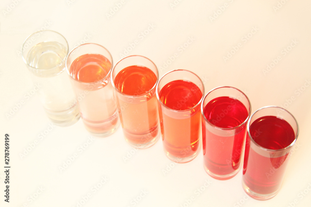 Five glasses of red liquid on white background, São Paulo, Brazil Five glasses of red liquid on white background, São Paulo, Brazil