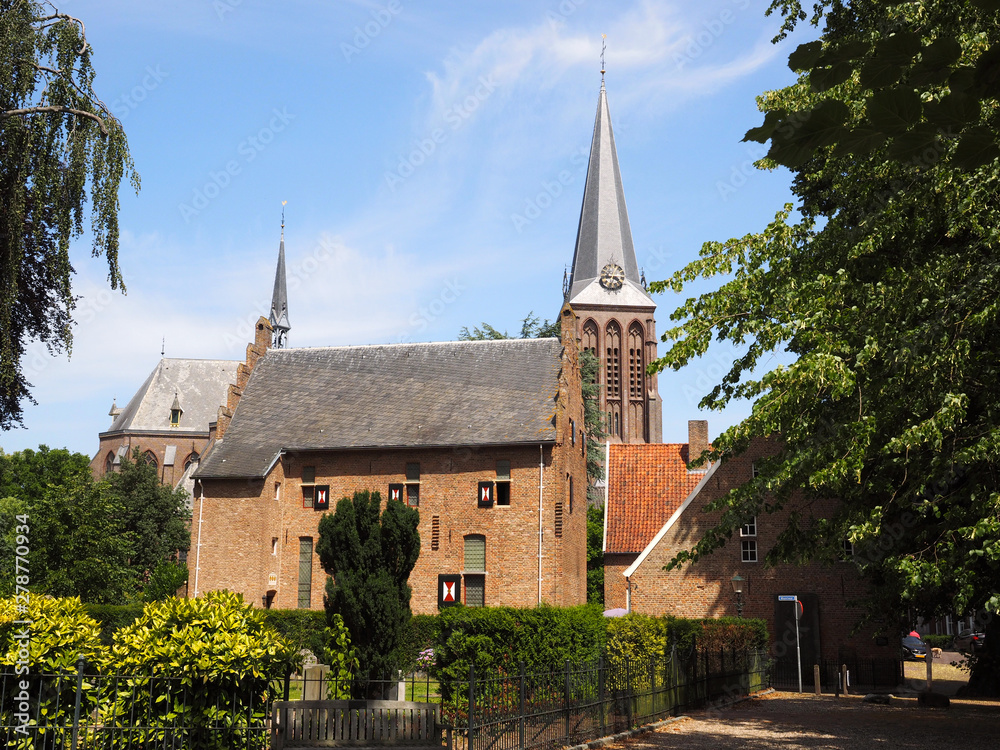 View on historic coin house in 's Heerenberg. On the background is the tower of the pancratiuskerk in 's heerenberg. View on historic coin house in 's Heerenberg. On the background is the tower of the pancratiuskerk in 's heerenberg.