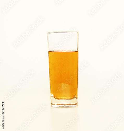 One glass of yellow and transparent liquid on white background, São Paulo, Brazil