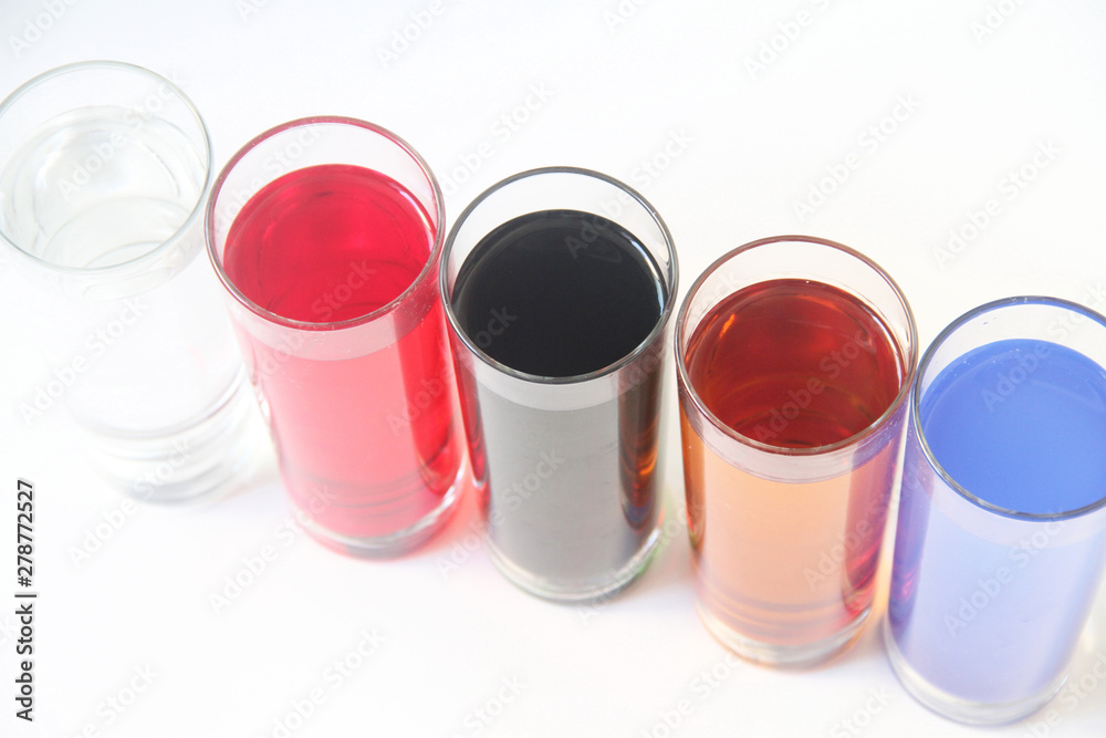 Five Glasses of multicoloured liquid on white background, São Paulo, Brazil Five Glasses of multicoloured liquid on white background, São Paulo, Brazil