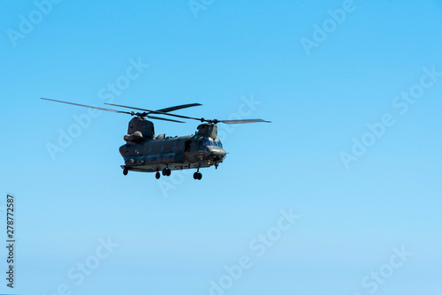 Fototapeta Naklejka Na Ścianę i Meble -  Sidmouth, Devon, England, July 2019.  A RAF Chinook heavy lift helicopter  flying along the south west coast at Sidmouth, Devon, UK