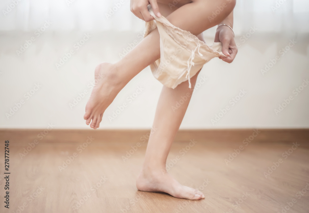 Young woman pull off her panties in the bedroom Stock Photo | Adobe Stock