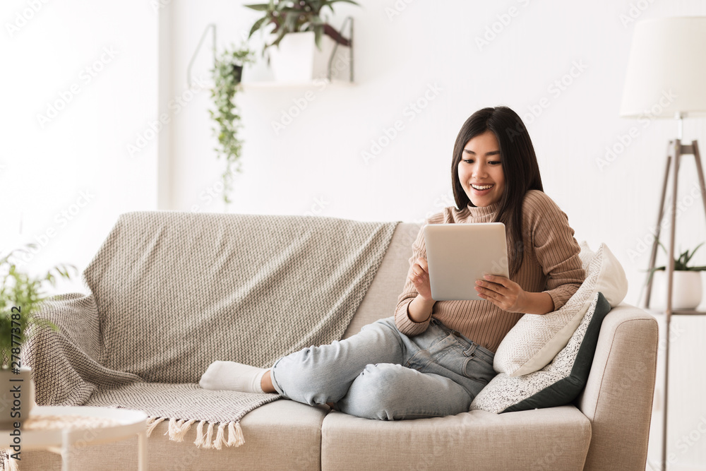 Asian Teenage Girl Watching Movie On Tablet Asian Teenage Girl Watching Movie On Tablet