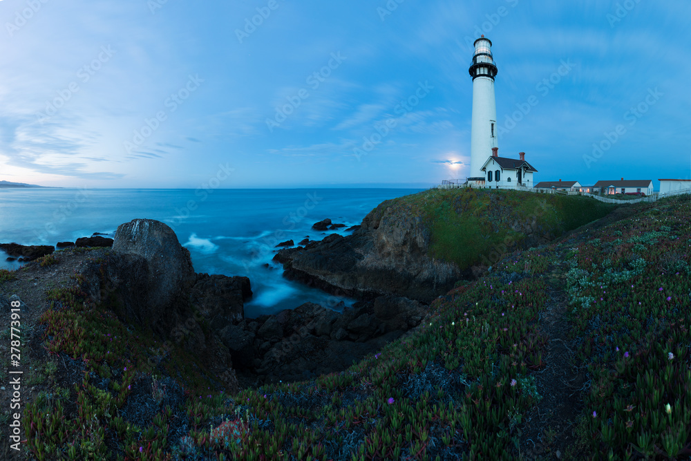 White pigeon point lighthouse with a blue sky  Historic Old Lighthouse at sunset - Pigeon Point Lighthouse - California, USA