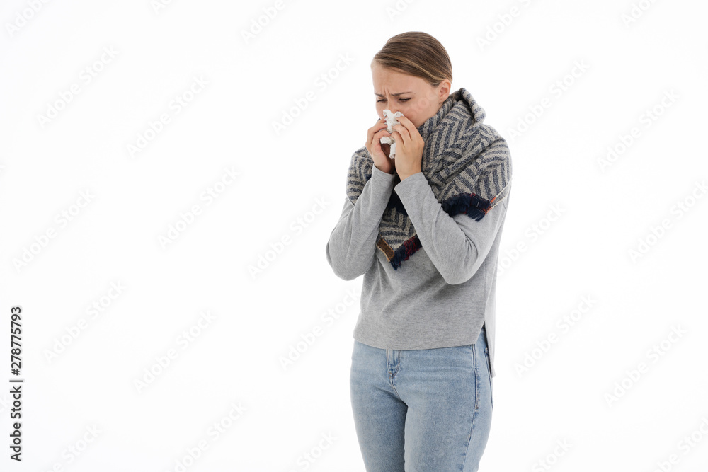 Young sick woman wrapped in a scarf on white background. Cold, flu, illness. Young sick woman wrapped in a scarf on white background. Cold, flu, illness.