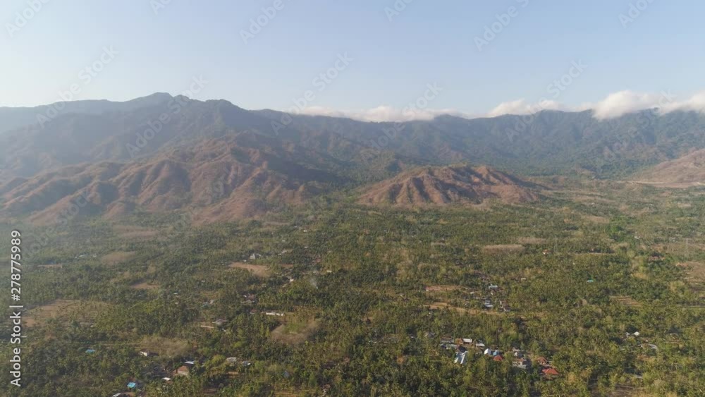 aerial view agricultural farmland with sown green,corn, tobacco field against mountains. agricultural crops in rural area Java Indonesia. Land with grown plants of paddy aerial view agricultural farmland with sown green,corn, tobacco field against mountains. agricultural crops in rural area Java Indonesia. Land with grown plants of paddy