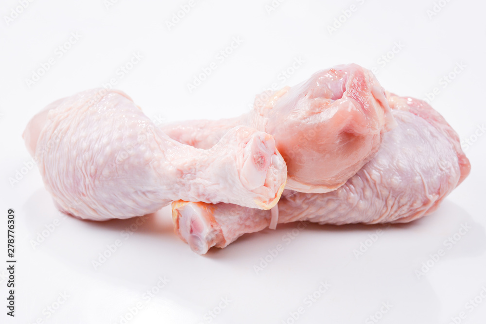 Tasty raw chicken legs. Top view. Isolated on white Tasty raw chicken legs. Top view. Isolated on white