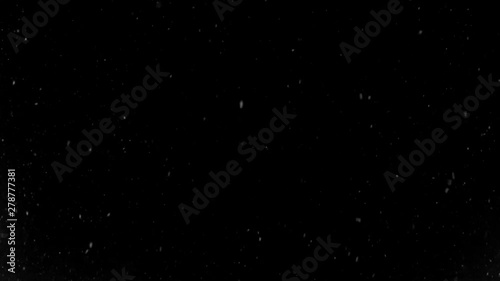 Falling snowflakes at winter, on black isolated background.