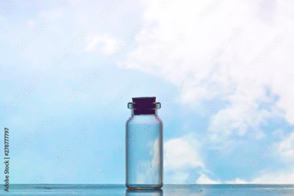 view of silhouette cork and glass bottle with blue sky as background view of silhouette cork and glass bottle with blue sky as background