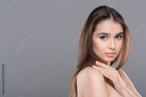 Perfect beautiful woman caressing her smooth shoulder