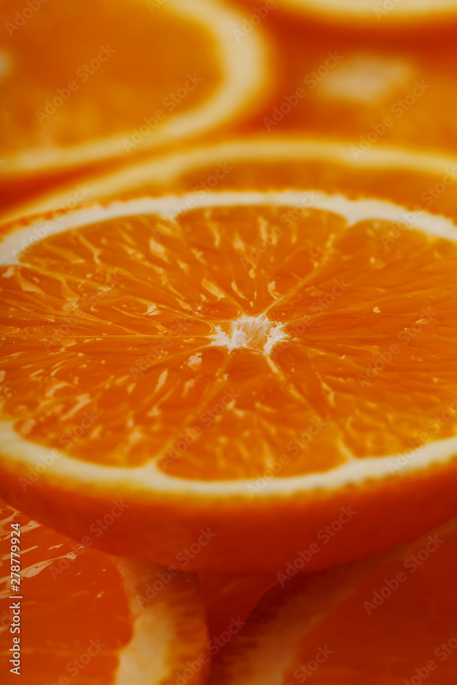 Slices of ripe orange backlit as a textural background. Full screen, close-up, macro