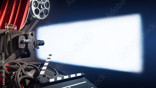 movie camera with film projects on the wall of the movie