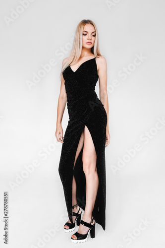 Beautiful blonde model in a long black dress