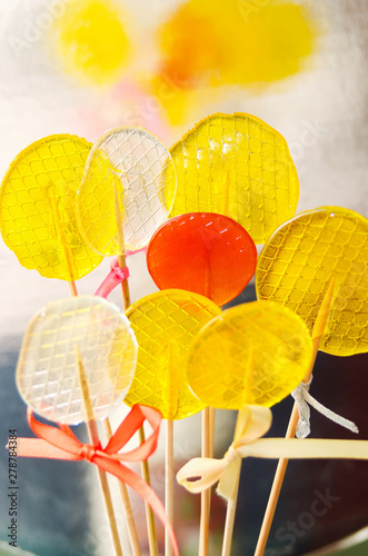 Isomalt lollipops cockerels on sticks candies. Candy, lollipop, bonbon, no-sugar candy. photo