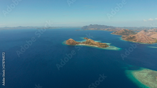aerial tropical landscape islands with blue lagoons, coral reef and sandy beach. Palawan, Philippines. Island Busuanga of the Malayan archipelago with turquoise lagoons.