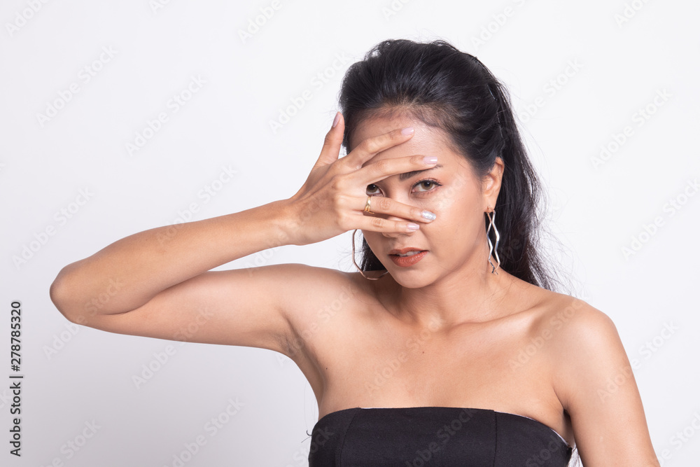 Beautiful young Asian woman peeking through fingers. Beautiful young Asian woman peeking through fingers.