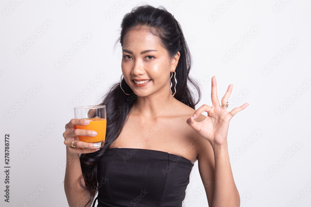 Young Asian woman drink orange juice show OK sign. Young Asian woman drink orange juice show OK sign.