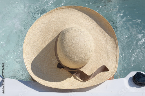Portrait from above of a big sun hat over a jacuzzi