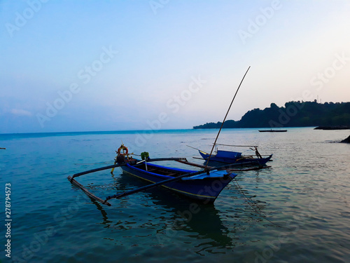 Traditional sailing wooden boat on the water parking at the harbour in summer holiday in Lampung, Indonesia