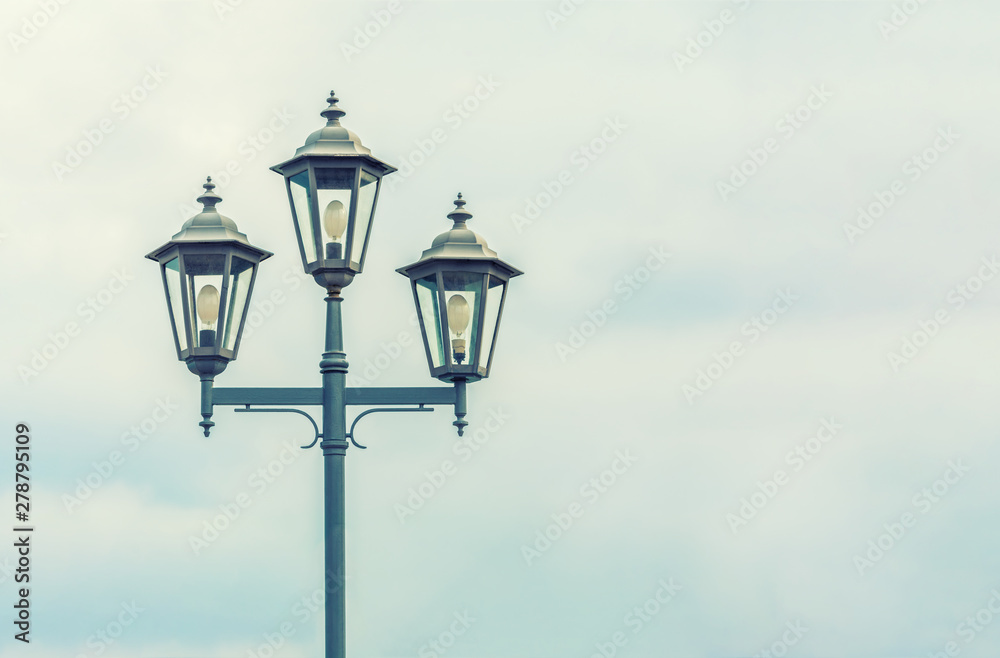 Old Street light. The sky with thunderclouds. Electric lighting of the modern city. Beautiful vintage lantern. Old Street light. The sky with thunderclouds. Electric lighting of the modern city. Beautiful vintage lantern.