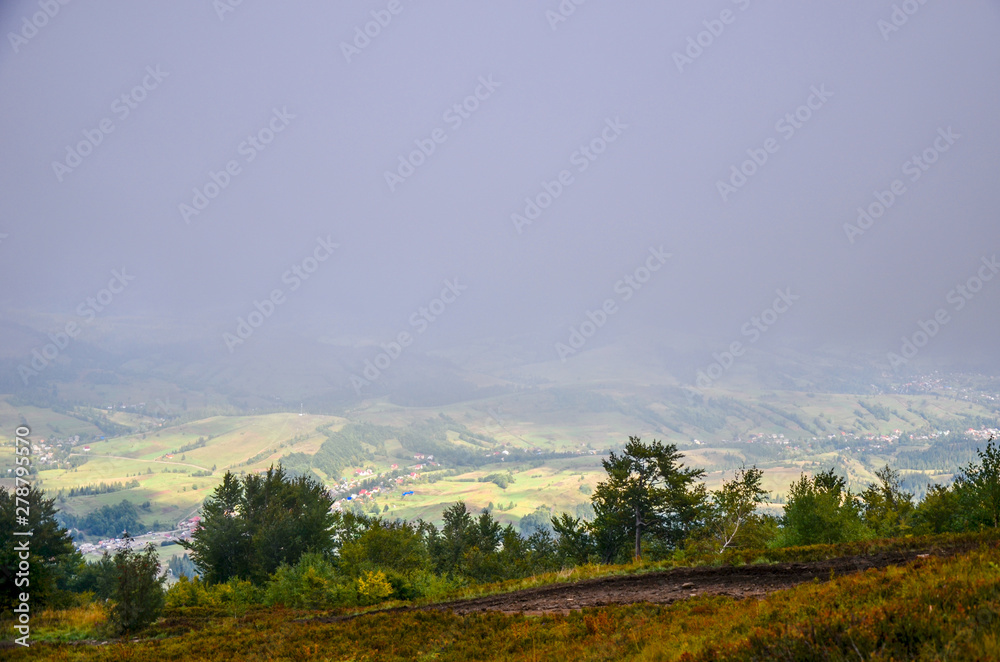 View of village covered in fog at Carpathian mountains