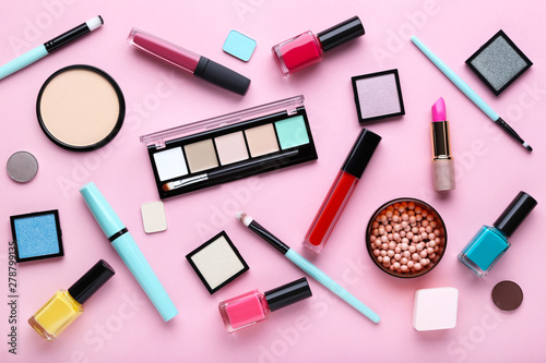 Different makeup cosmetics on pink background