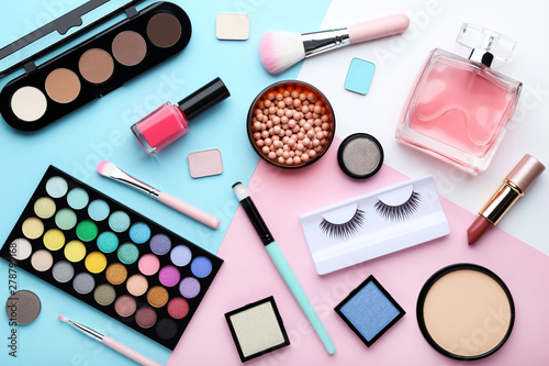 Makeup cosmetics with perfume bottle on colorful background