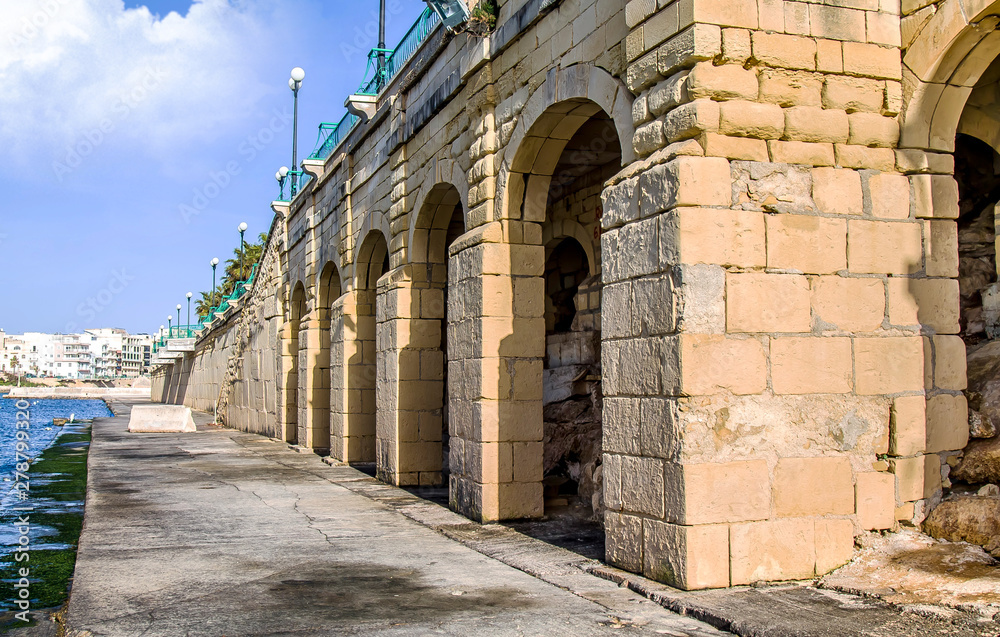 Sandstone brick embankment on a clear day in Malta