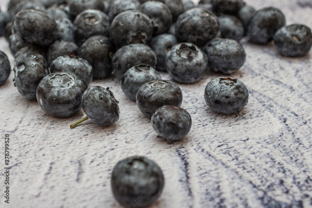 Blueberries with water drops on concrete background. Blueberries with water drops on concrete background.