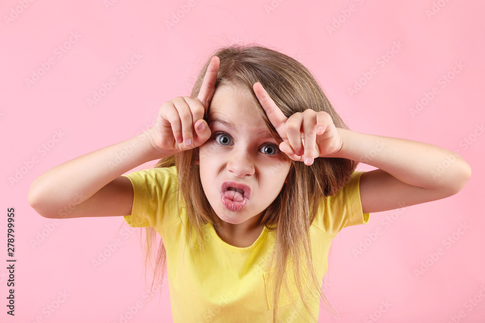 Emotional little girl on pink background Emotional little girl on pink background