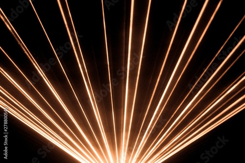 Orange laser show nightlife club stage shining sparkling rays. Luxury entertainment in nightclub event, festival, concert or New Years Eve. Ray beams are symbol for science and universe research
