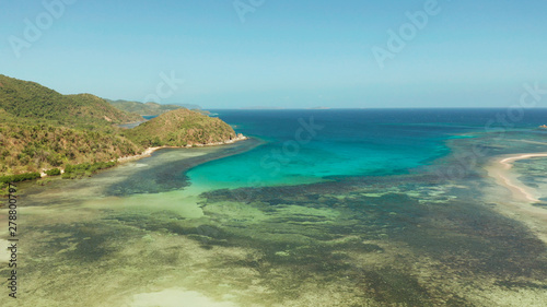 Aerial view coastline of a tropical island with coral reef and blue lagoon. Busuanga, Palawan, Philippines. tropical landscape © Alex Traveler
