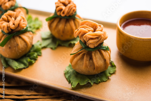 Crispy Potli Samosa or veg money bags are delicious Indian snacks of spiced aloo and mix veggies Or Meat/kheema  stuffed in flaky dough. It's a great creative starter or appetiser. served with ketchup photo