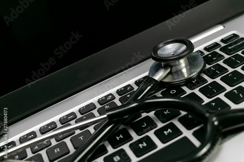 Medical technology concept - Medical stethoscope on a modern laptop