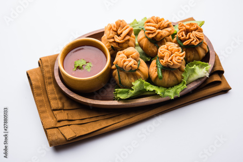 Crispy Potli Samosa or veg money bags are delicious Indian snacks of spiced aloo and mix veggies Or Meat/kheema  stuffed in flaky dough. It's a great creative starter or appetiser. served with ketchup photo