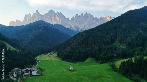 Aerial view of Santa Maddalena church in Dolomites, Italian Alps.Val Di Funes valley from drone.