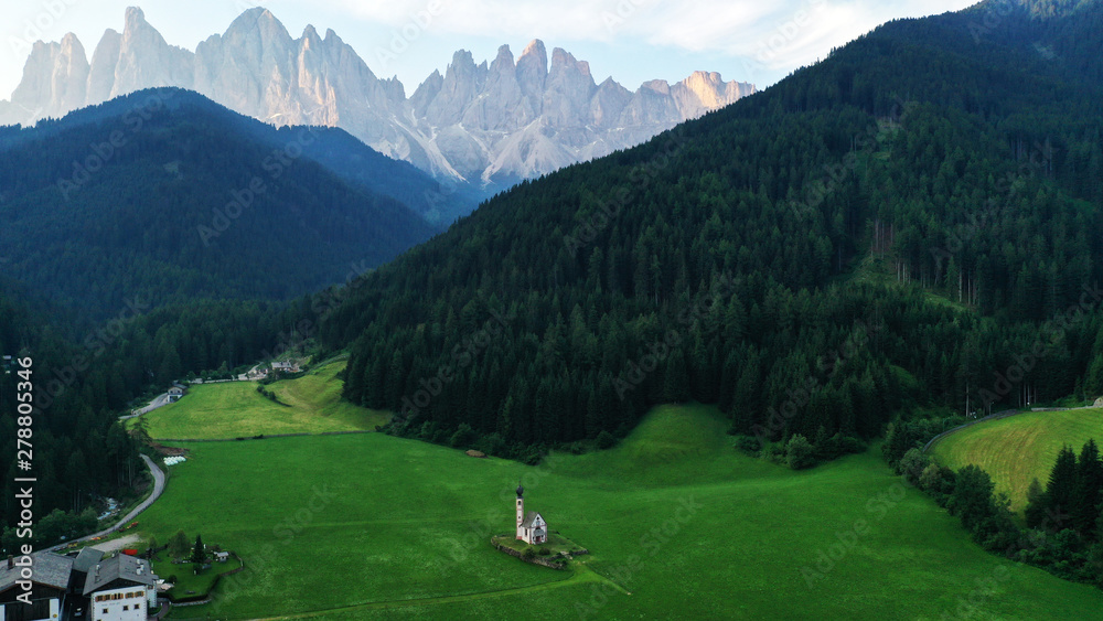 Aerial view of Santa Maddalena church in Dolomites, Italian Alps.Val Di Funes valley from drone.