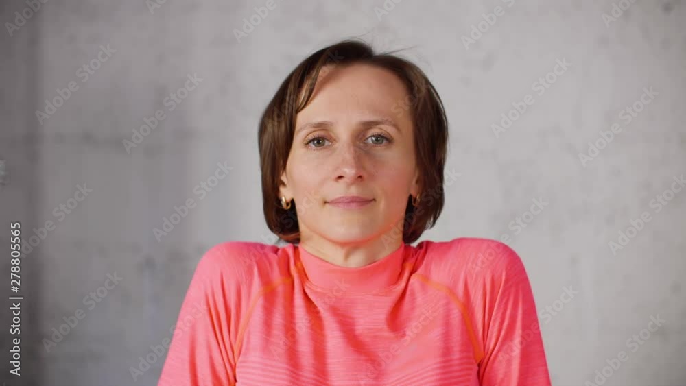 Portrait fitness woman training shoulders gymnastics on white background in studio. Sport woman showing exercise for shoulders for fitness blog Portrait fitness woman training shoulders gymnastics on white background in studio. Sport woman showing exercise for shoulders for fitness blog