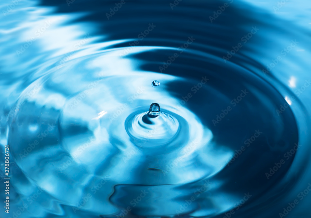 Water splash close-up. Drop of water. Blue water drop. Falling water Water splash close-up. Drop of water. Blue water drop. Falling water