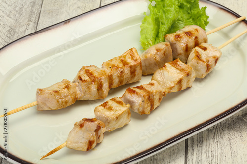 Grilled pork skewer served salad