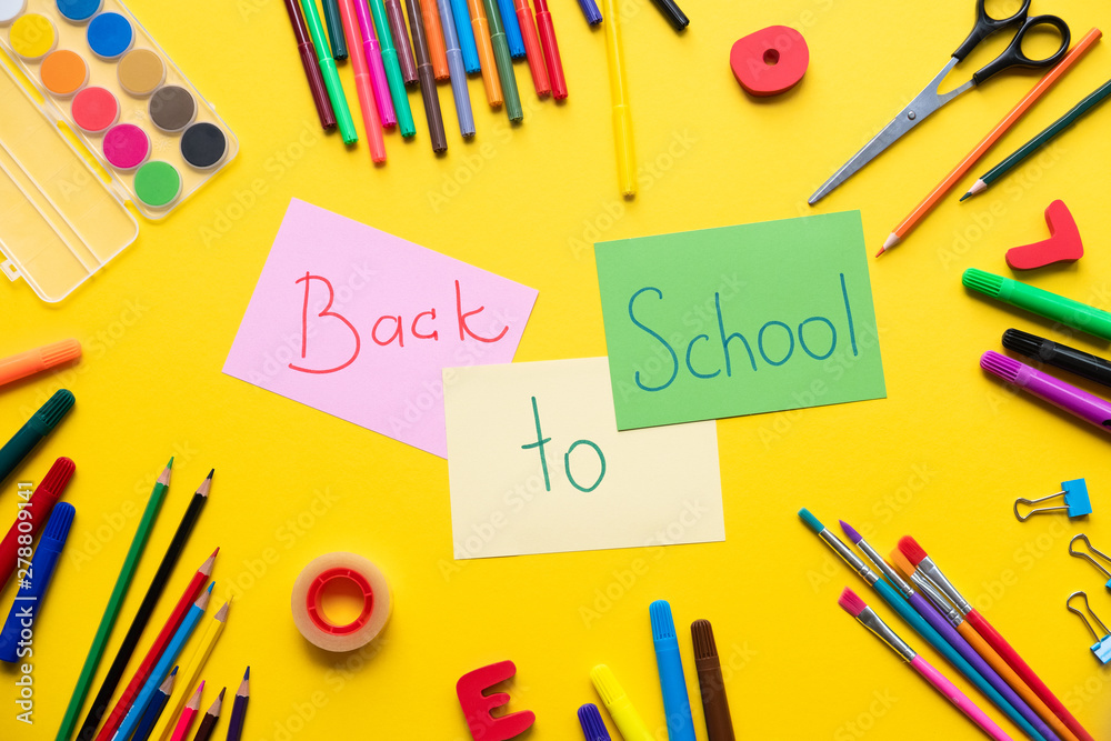 School supplies on yellow background. Concept back to school. School supplies on yellow background. Concept back to school.