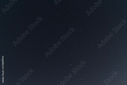 Night sky low light photo. A lot of stars and constellations on dark sky. Stock photo of deep sky. Far away from city and no clouds.