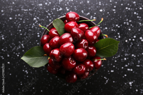 Bunch of fresh organic sweet cherries on textured background. Clean eating concept. Healthy nutritious vegan snack, raw diet. Close up, copy space, top view, flat lay.