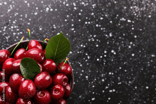Bunch of fresh organic sweet cherries on textured background. Clean eating concept. Healthy nutritious vegan snack, raw diet. Close up, copy space, top view, flat lay.