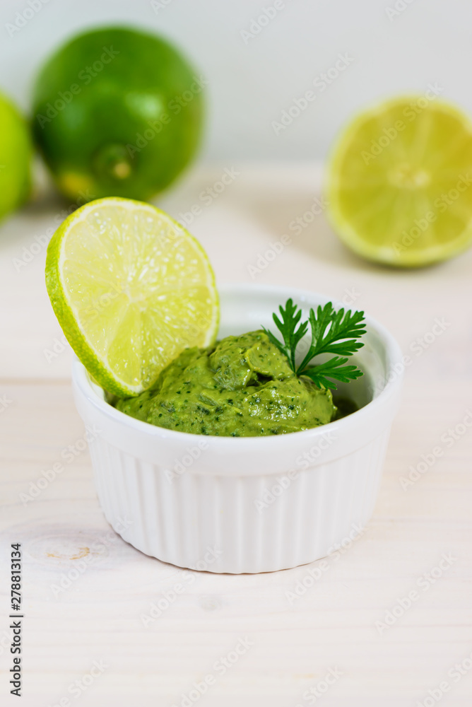 Guacamole from avocado, lime, cilantro and garlic on wooden table. Guacamole from avocado, lime, cilantro and garlic on wooden table.